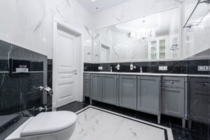 prestige bathroom with large mirror and glowing chandelier