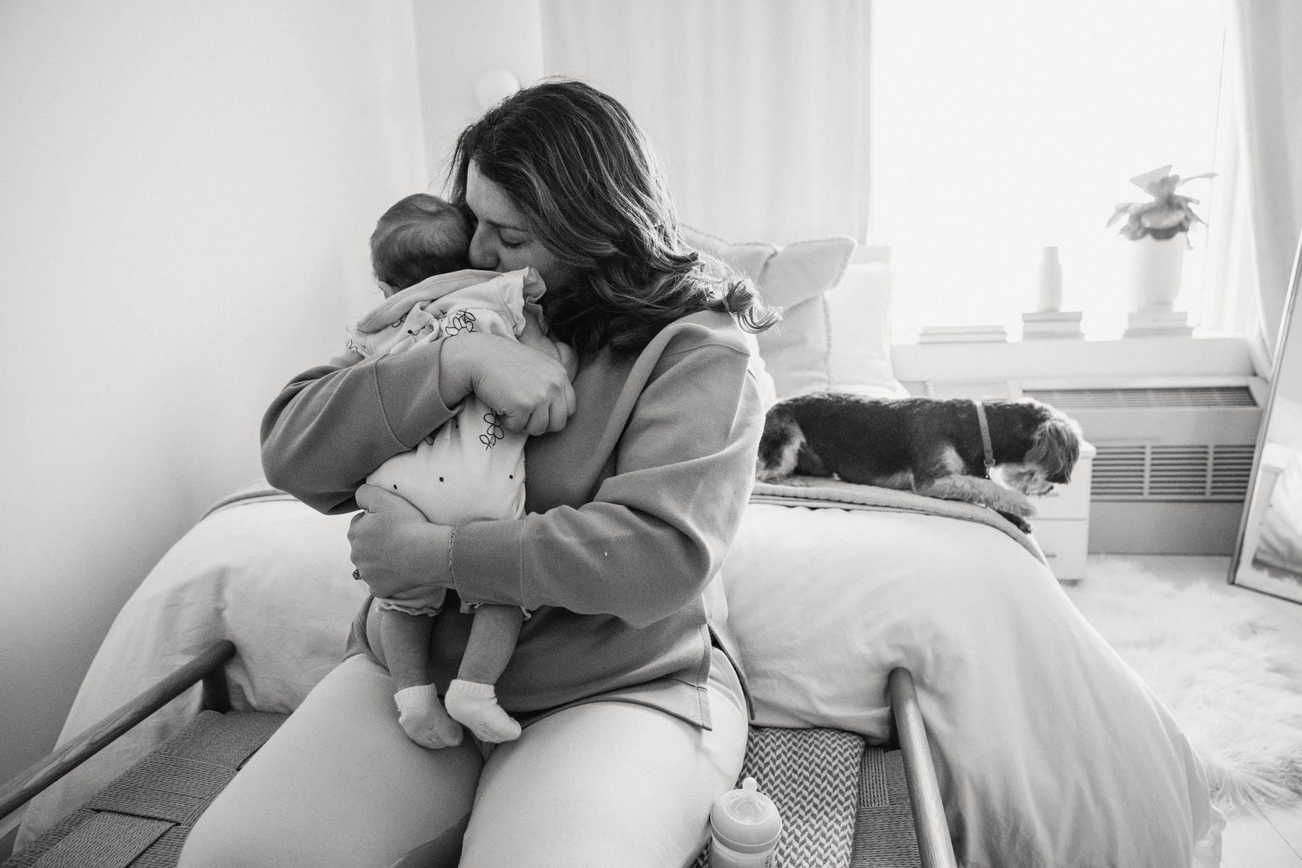 loving mother kissing little baby